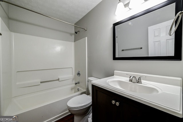 full bathroom featuring vanity, a textured ceiling, toilet, and  shower combination