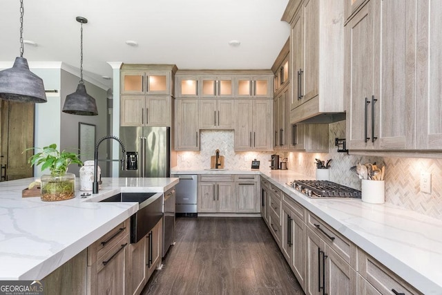 kitchen with tasteful backsplash, sink, decorative light fixtures, and appliances with stainless steel finishes