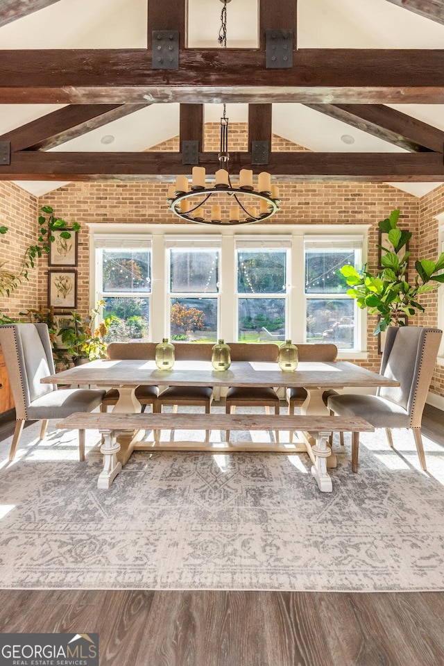 unfurnished sunroom with vaulted ceiling with beams, plenty of natural light, and a notable chandelier