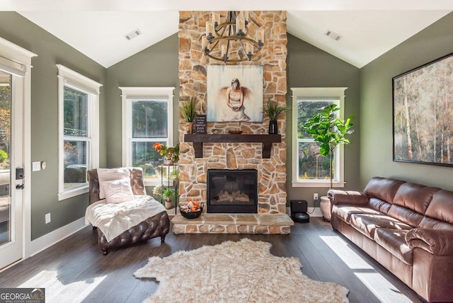 living room featuring plenty of natural light, dark hardwood / wood-style flooring, a fireplace, and vaulted ceiling