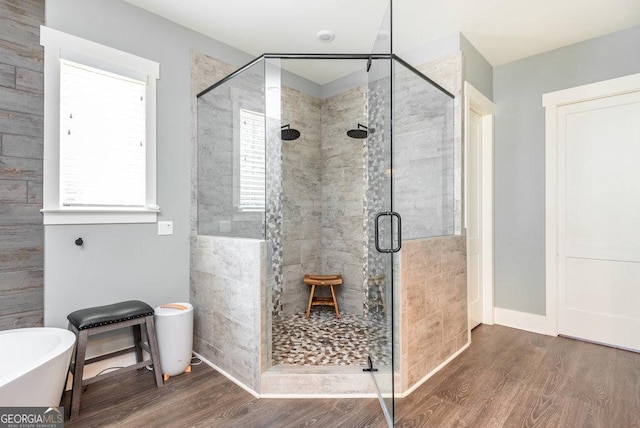 bathroom featuring wood-type flooring and independent shower and bath