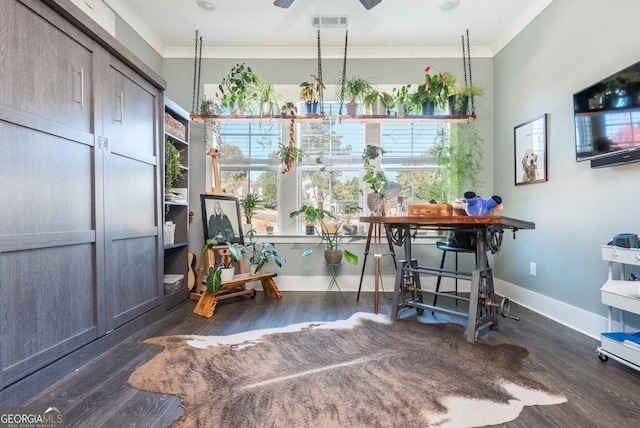 interior space featuring ceiling fan, ornamental molding, and dark wood-type flooring