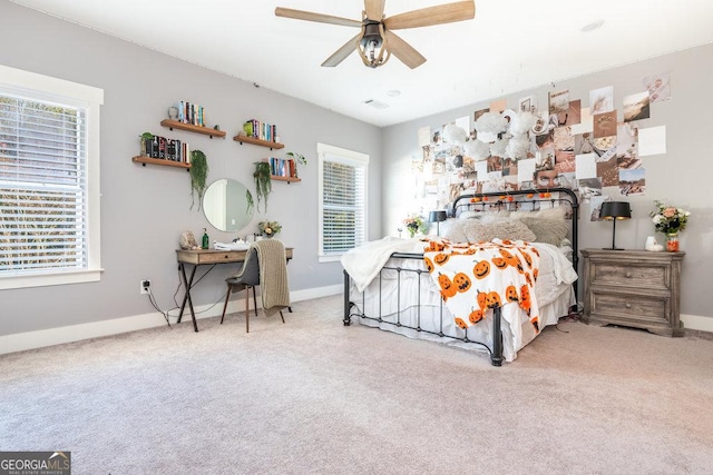 bedroom featuring carpet, ceiling fan, and multiple windows