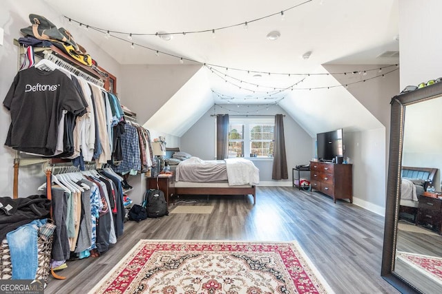 bedroom featuring wood-type flooring and vaulted ceiling