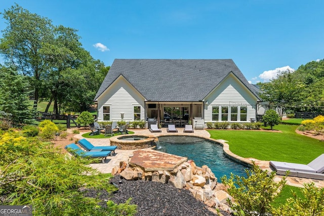 view of swimming pool with an in ground hot tub, a yard, and a patio area