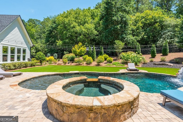 view of swimming pool featuring a patio area and an in ground hot tub