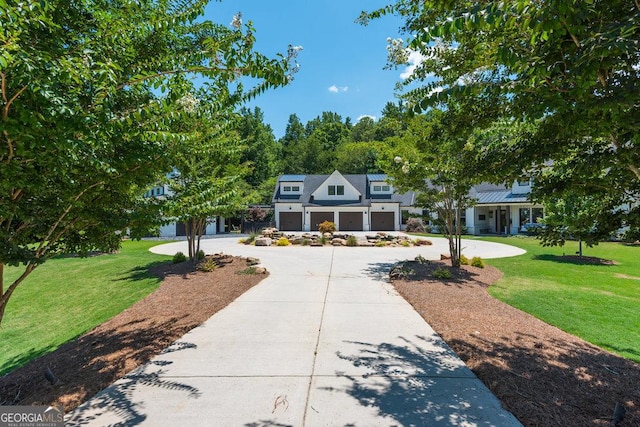 view of front of home with a front yard and a garage