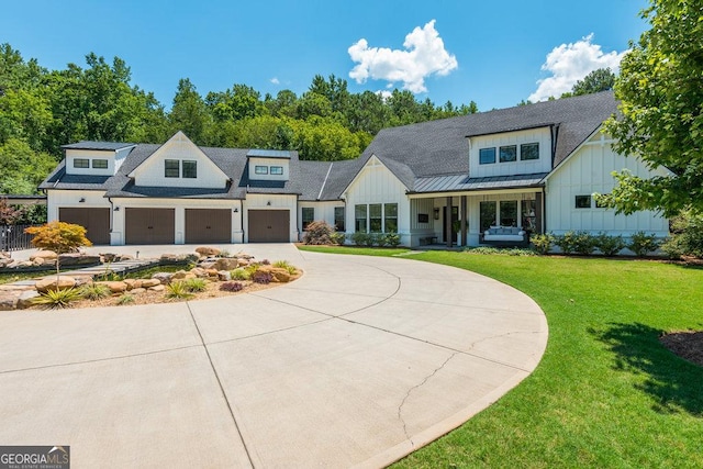 modern farmhouse style home featuring covered porch and a front yard