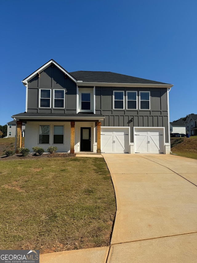 view of front of property featuring a garage and a front yard