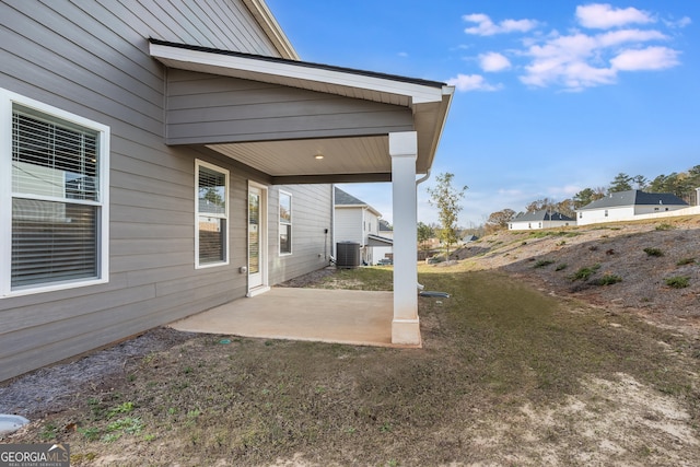 view of yard with a patio area and central air condition unit