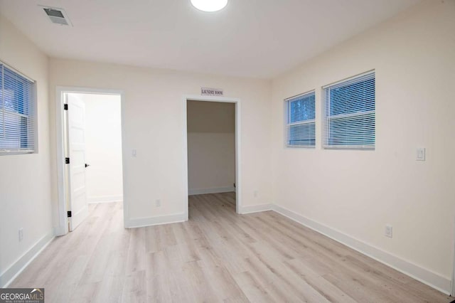 unfurnished room with light wood-type flooring