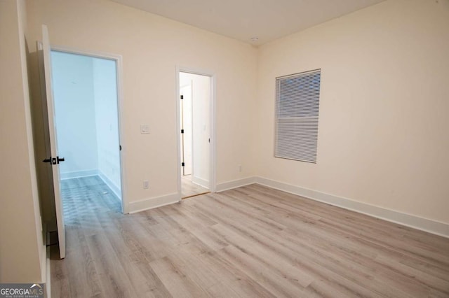 unfurnished room with light hardwood / wood-style flooring