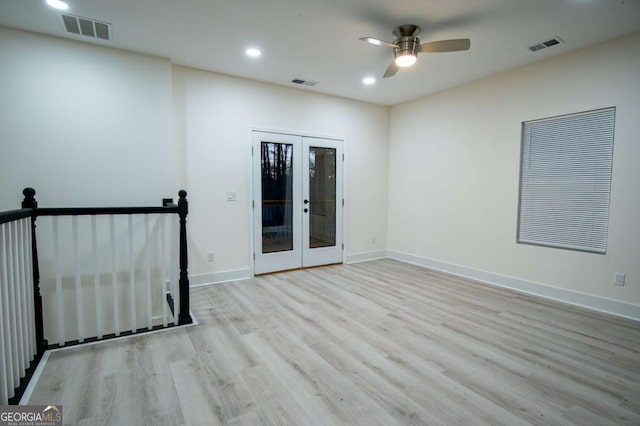 spare room with ceiling fan, french doors, and light hardwood / wood-style floors