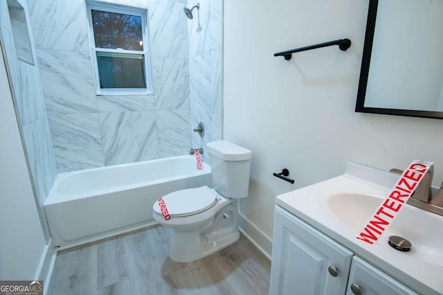 full bathroom with wood-type flooring, vanity, toilet, and tiled shower / bath