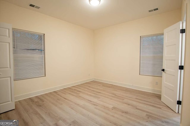 spare room with light hardwood / wood-style floors