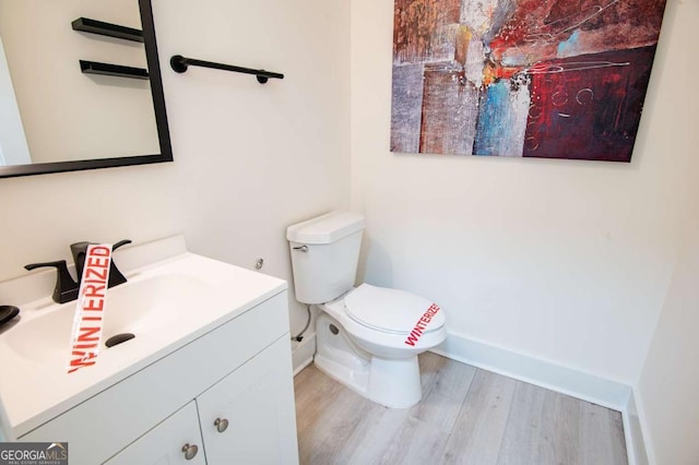 bathroom featuring hardwood / wood-style floors, vanity, and toilet