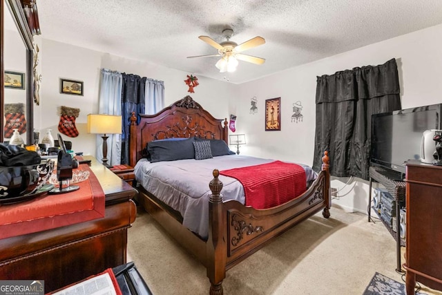 carpeted bedroom with ceiling fan and a textured ceiling