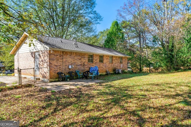 back of property with a patio area, a yard, and central air condition unit