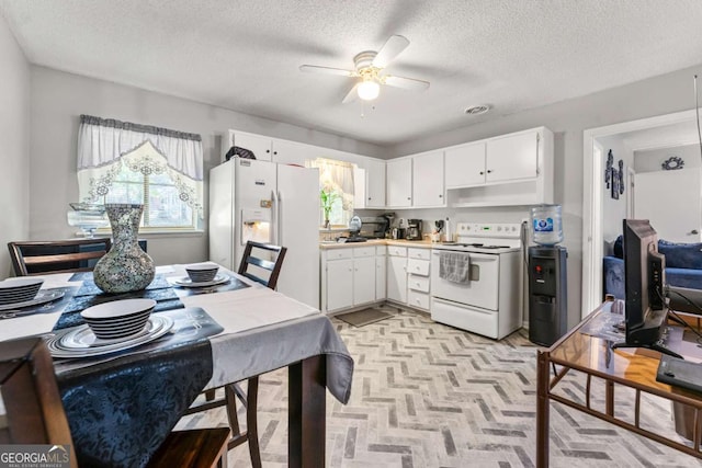 kitchen with a textured ceiling, ceiling fan, white cabinets, and white appliances