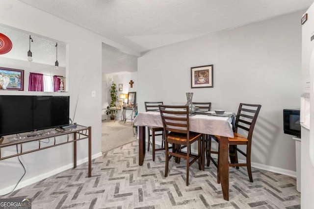 dining room featuring a textured ceiling