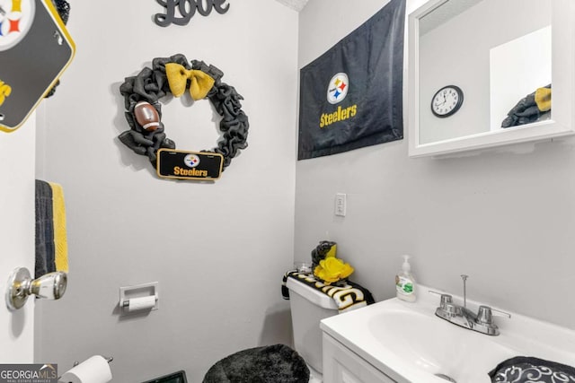 bathroom featuring vanity and toilet