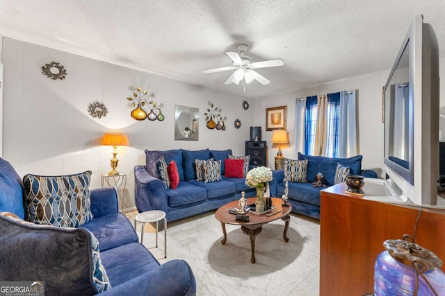 living room featuring a textured ceiling and ceiling fan