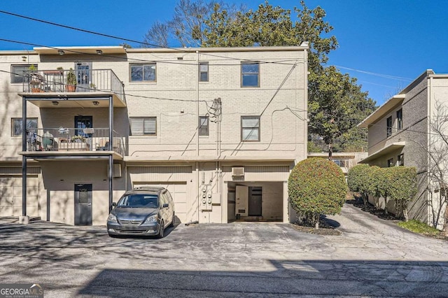 exterior space featuring a garage and a balcony