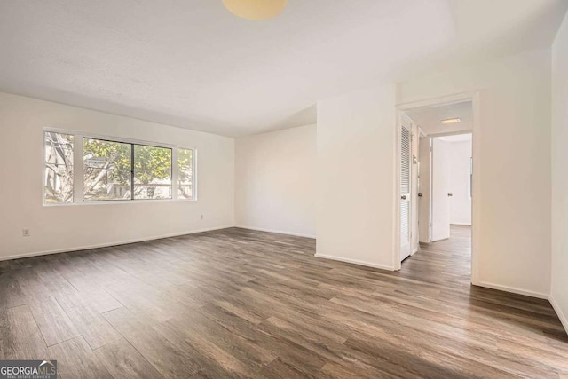 empty room with dark wood-type flooring