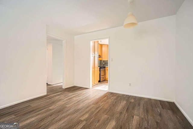 empty room featuring dark hardwood / wood-style flooring