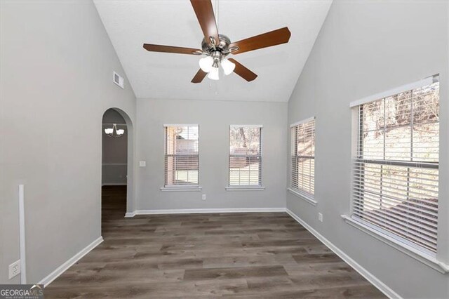 empty room with ceiling fan, dark wood-type flooring, and high vaulted ceiling