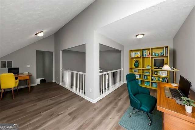 home office with hardwood / wood-style flooring and lofted ceiling