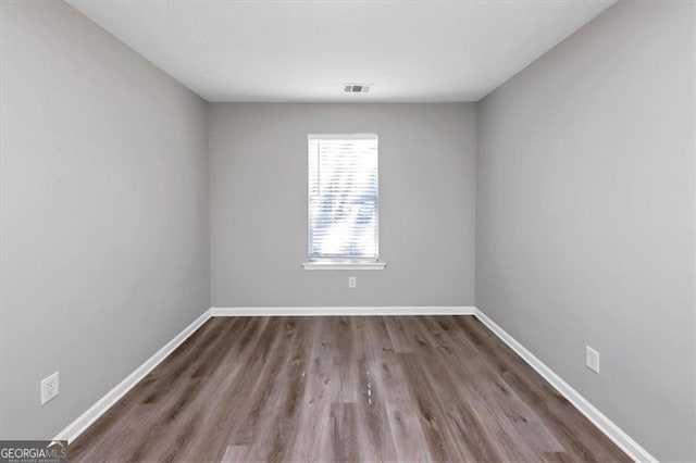 spare room with hardwood / wood-style flooring