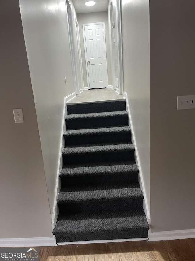 stairs with hardwood / wood-style flooring