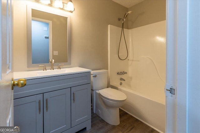 full bathroom featuring shower / bathtub combination, vanity, toilet, and hardwood / wood-style floors