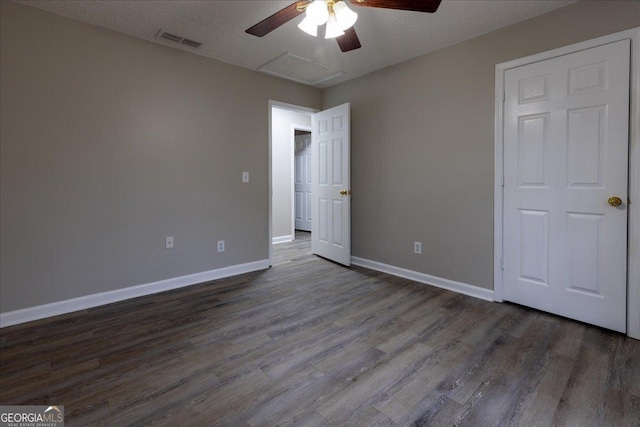 unfurnished bedroom with ceiling fan, wood-type flooring, and a textured ceiling