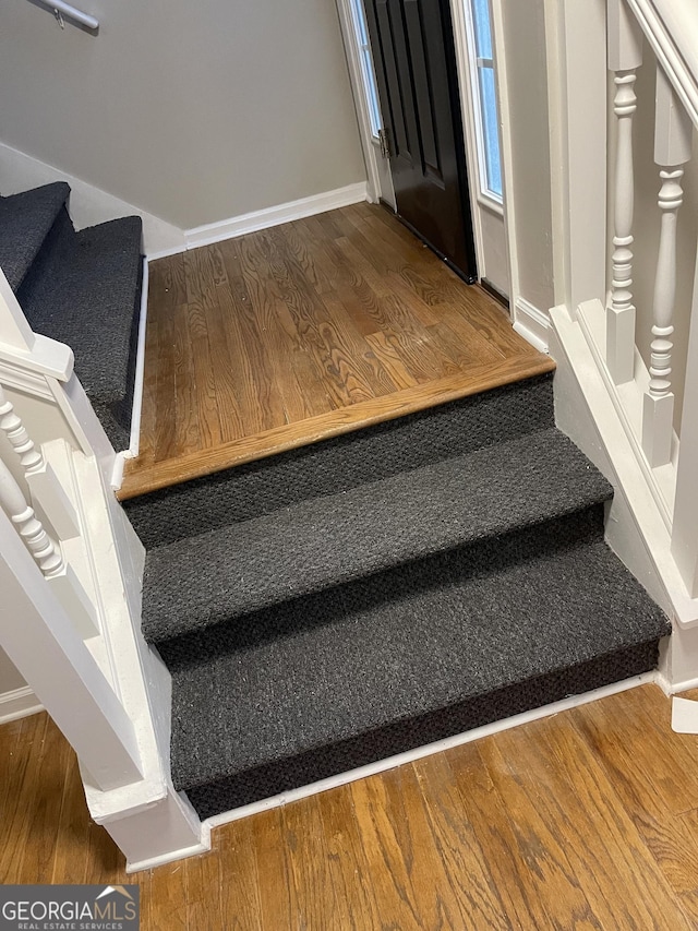 staircase featuring wood-type flooring