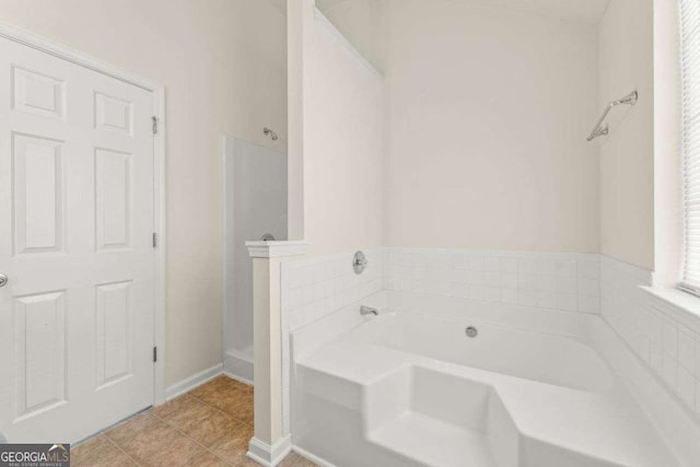 bathroom featuring a tub to relax in and tile patterned flooring