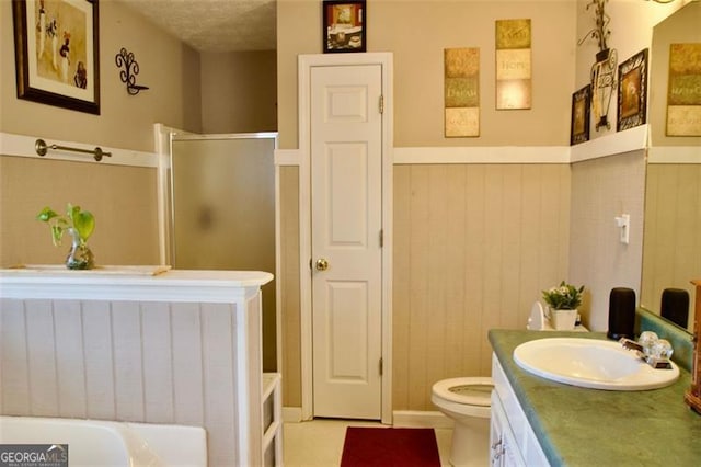 bathroom featuring a textured ceiling, vanity, toilet, and an enclosed shower