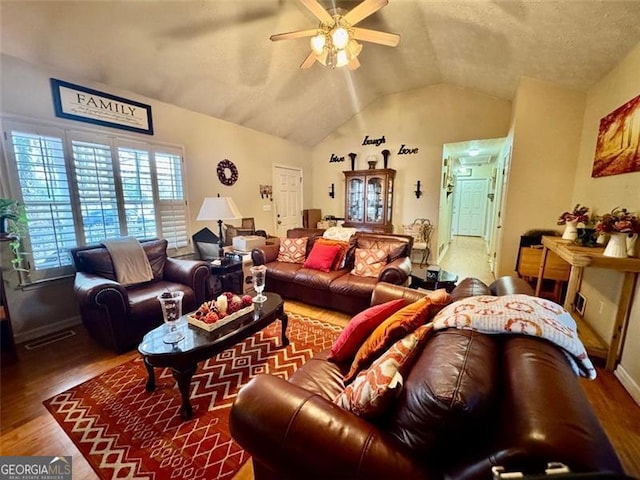 living room featuring wood-type flooring, vaulted ceiling, and ceiling fan