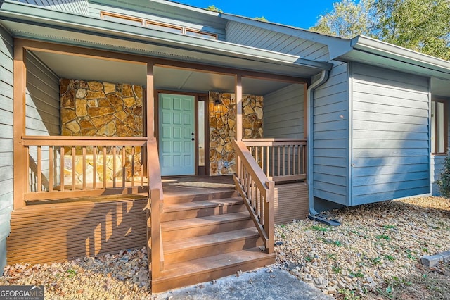 view of exterior entry with a porch