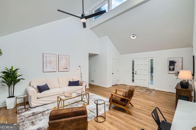 living room with wood-type flooring, high vaulted ceiling, and ceiling fan