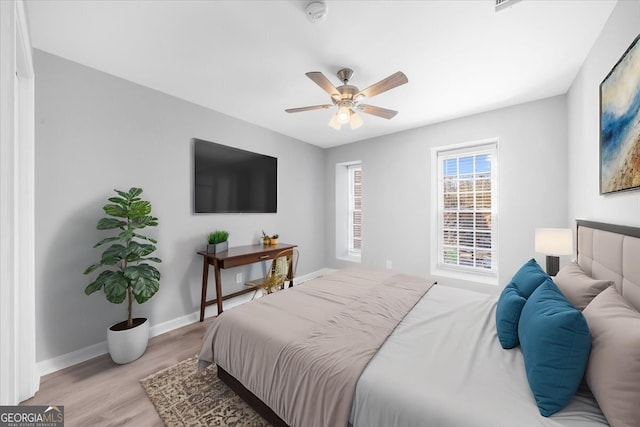 bedroom with ceiling fan and light wood-type flooring