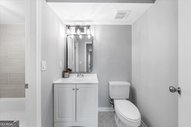 bathroom featuring vanity and toilet