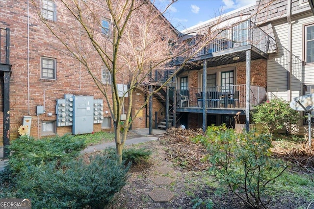 back of house featuring a balcony