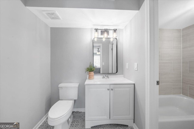 bathroom with a washtub, toilet, and vanity