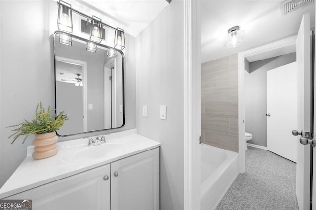 full bathroom featuring ceiling fan, toilet, plus walk in shower, and vanity