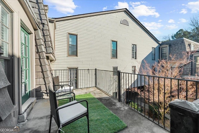 view of patio with grilling area and a balcony