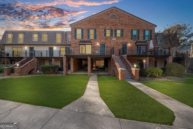 view of front of house with a patio area, a deck, and a yard