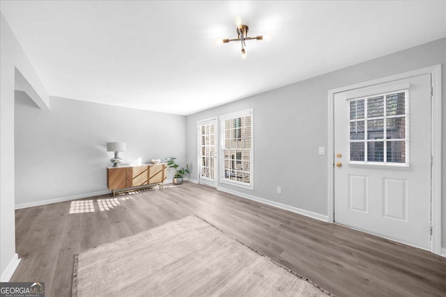 interior space with hardwood / wood-style floors and an inviting chandelier