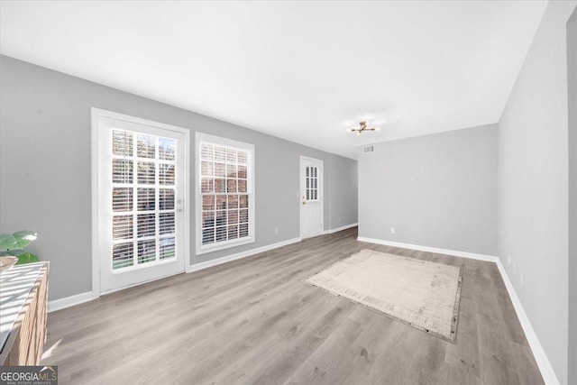 spare room featuring light hardwood / wood-style flooring